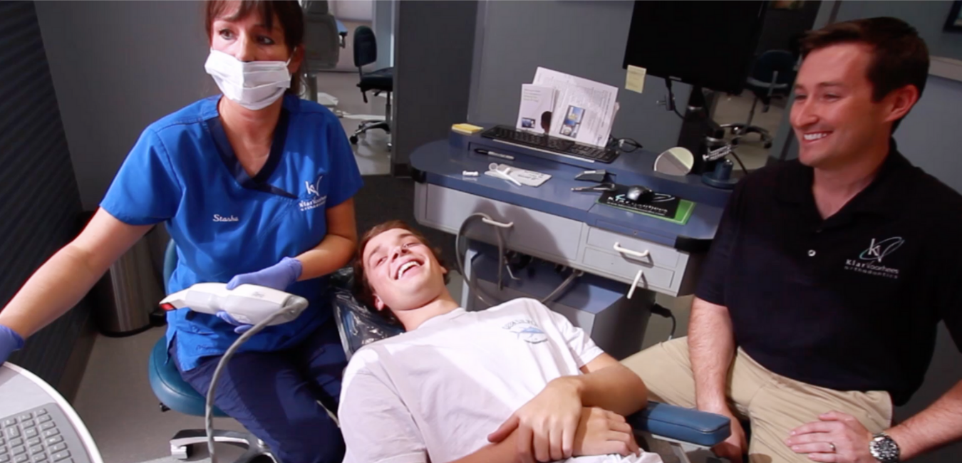 Dentist and assistant sit and examine xray on screen with patient | Videos for Small Businesses