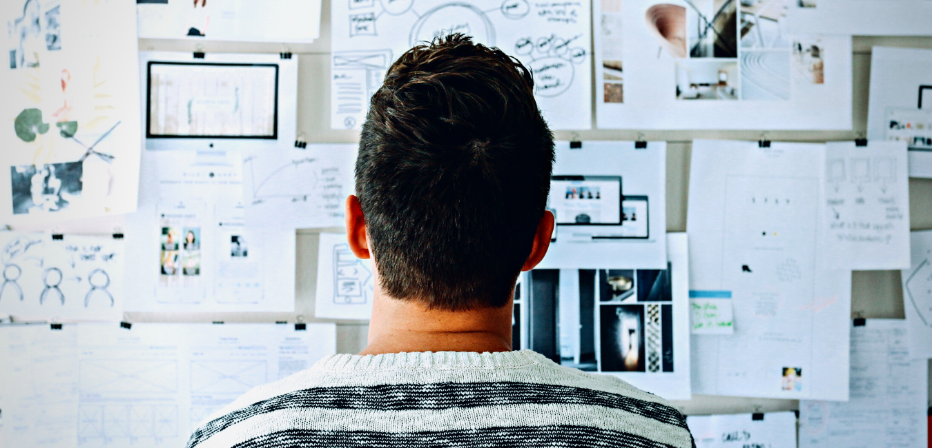 Man staring at wall planning business' 2025 Marketing Plan - Rogers Advertising