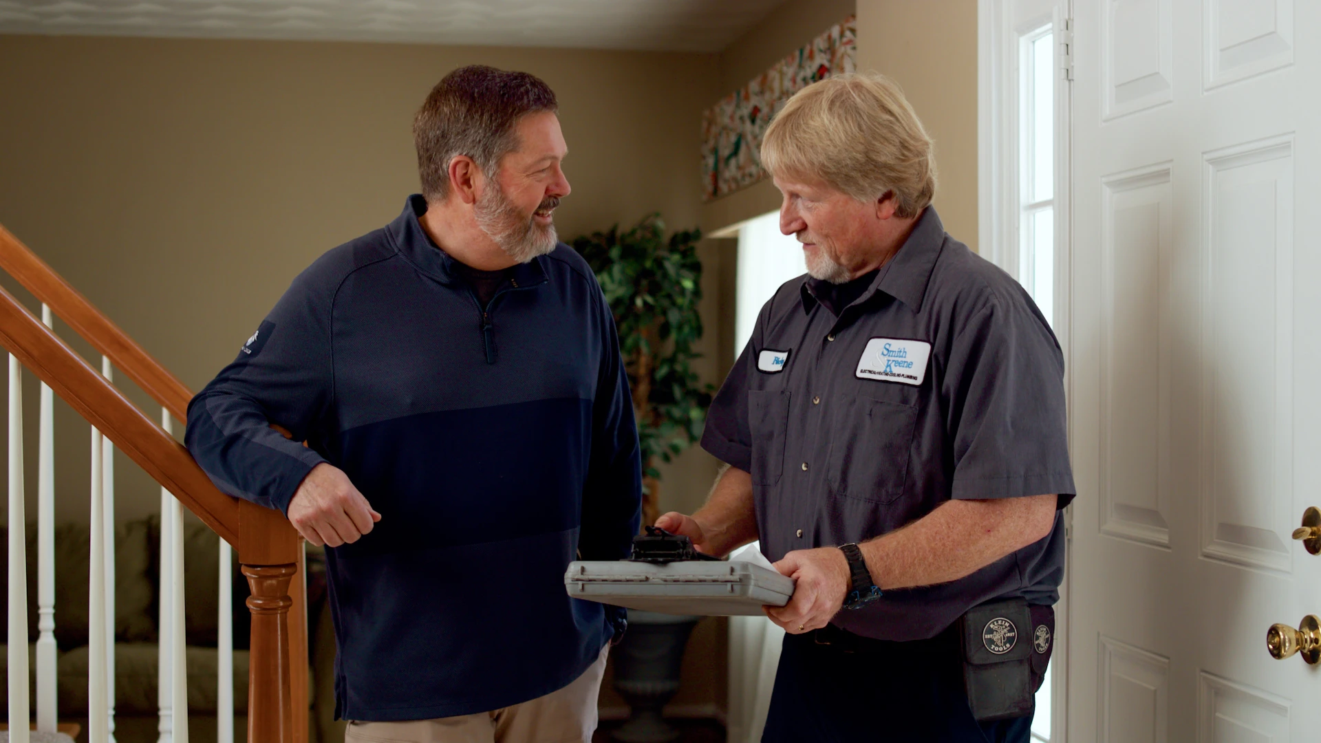 HVAC technician speaking with a homeowner